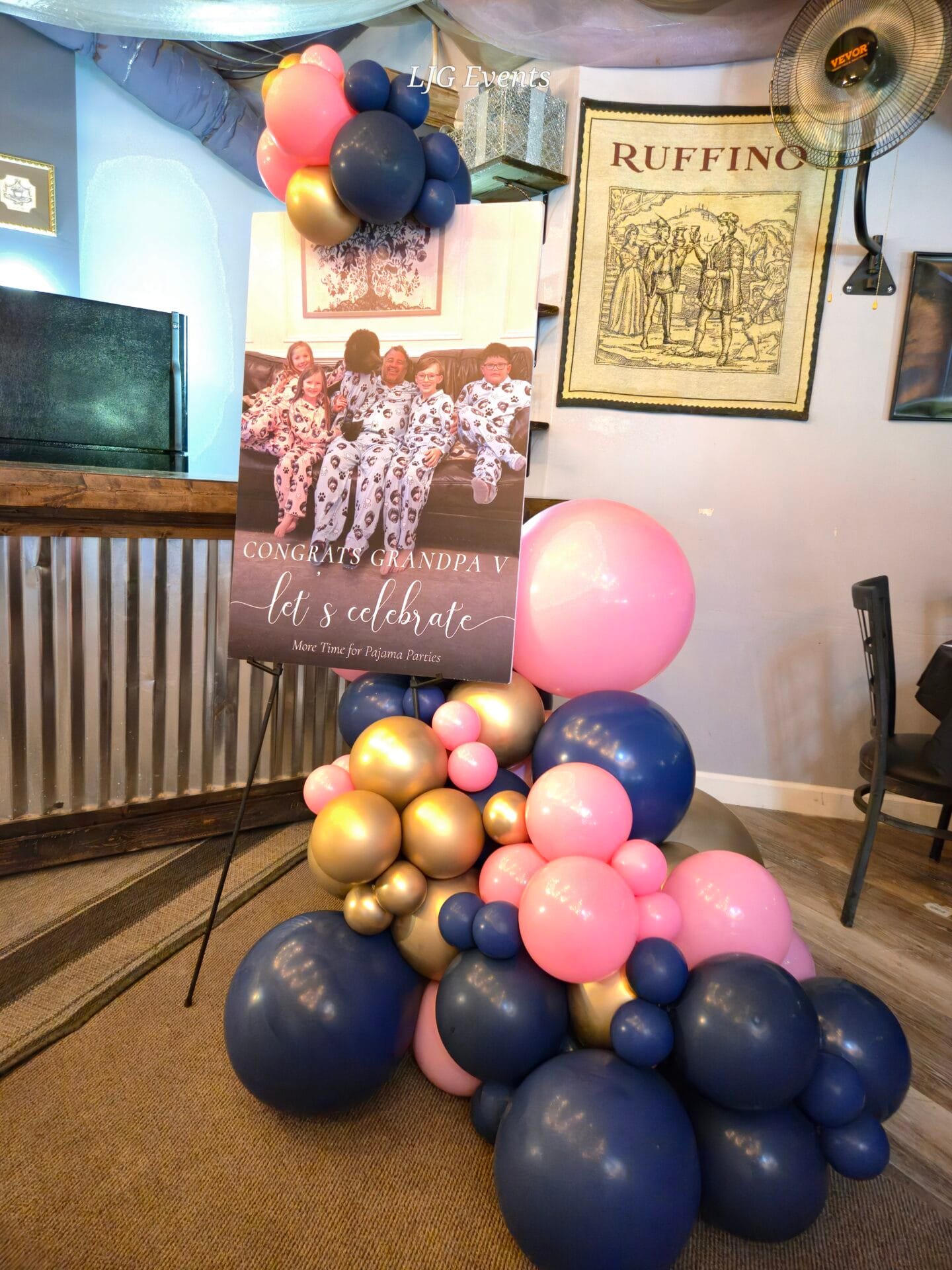 Retirement party sign with pink and navy balloons