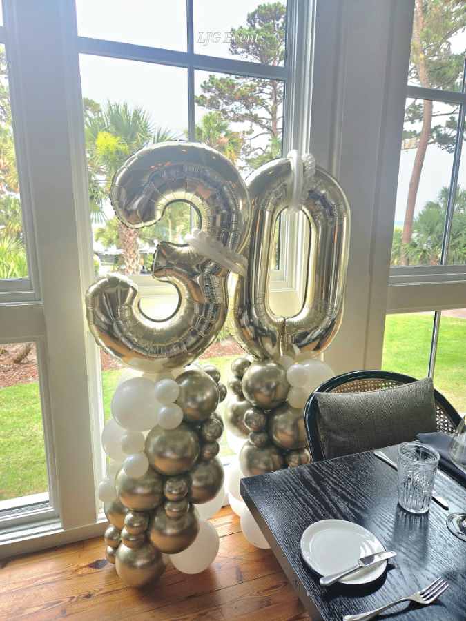 Silver 30 balloon decoration by window.