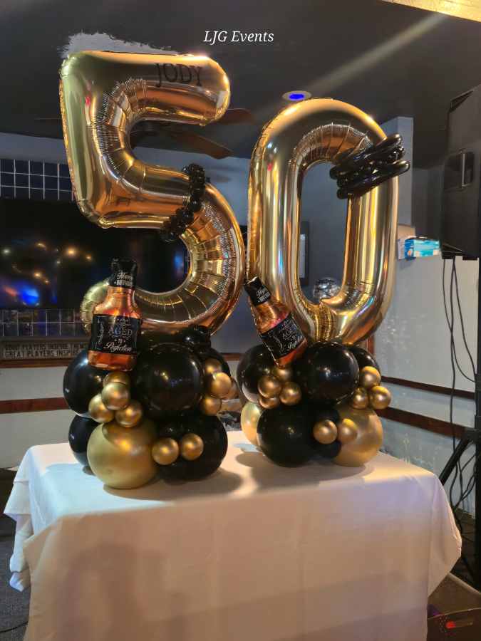 Gold 50 balloons with black decorations.