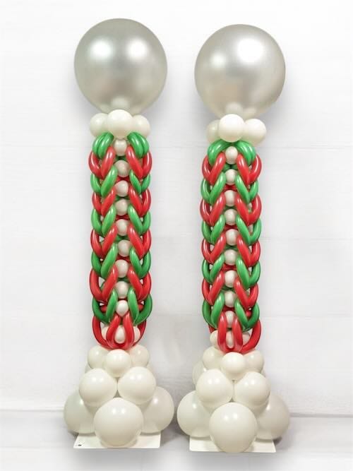 Twisted balloon columns with red, green, and white balloons.