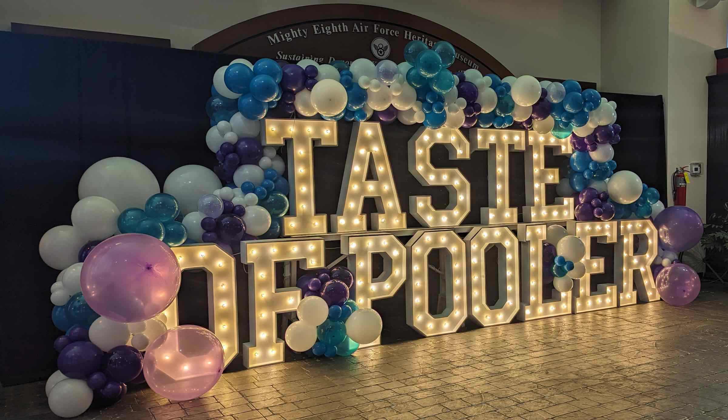 A light display that says A Taste of Pooler with a balloon display over it.