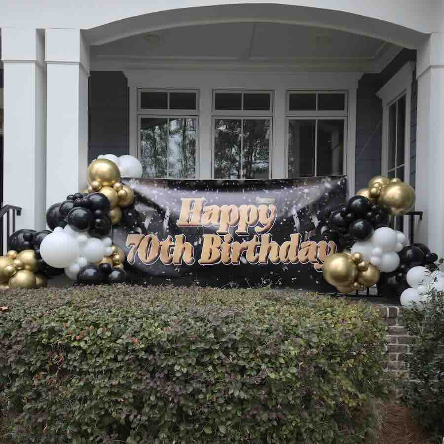 Happy 70th birthday banner with black gold balloons