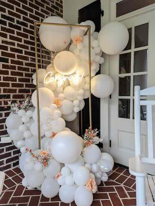 White balloon display with 'Congrats' sign