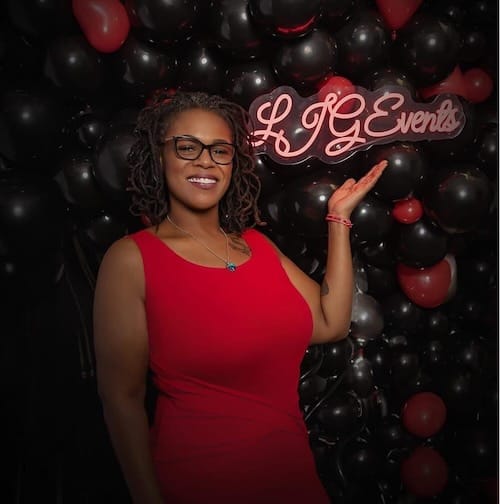 Person in red dress at LJG Events backdrop.